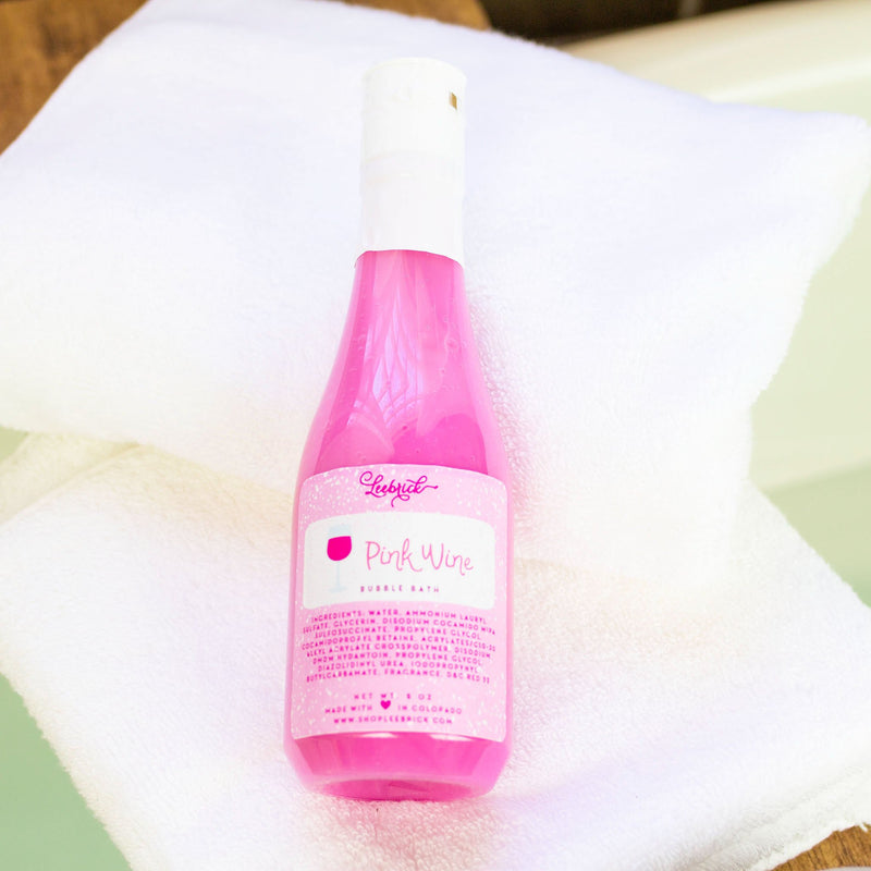 Bottle of Pink Wine Bubble Bath on white bath towel
